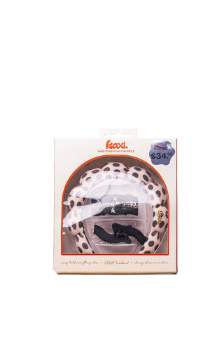 A packaged hair accessory set by Kaxi, featuring a leopard-print hair tie and a black scrunchie inside a white cardboard box with a clear window.
