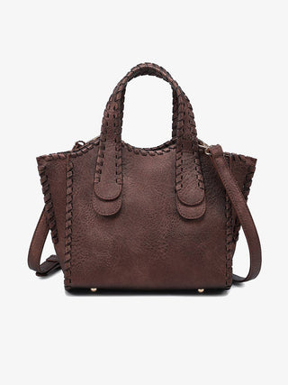 Brown leather handbag with braided handle and strap on a white background