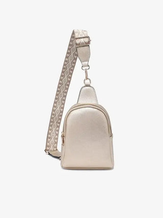 Beige crossbody bag with a patterned strap on a white background