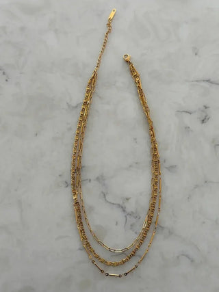 Gold necklace on a marble surface