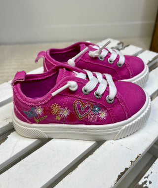 Pair of pink children's sneakers with floral and heart designs on a white surface.