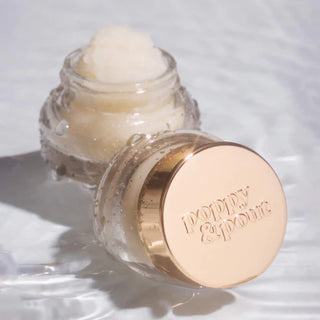 Skincare product with gold cap on a white background