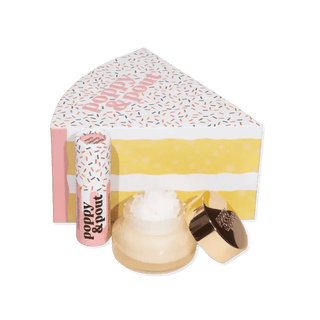 Lip balm set with a cake-shaped container on a green background