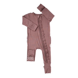 Pink baby onesie with ruffled details on a white background