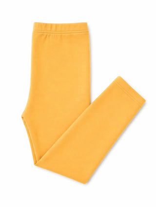 A pair of solid mustard yellow leggings folded neatly on a clean white background.
