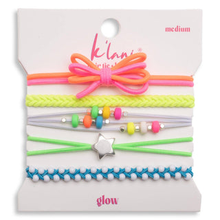 A set of six colorful kids' hair ties on a white cardboard display card. The set includes a pink and orange bow, a neon yellow-green braided tie, a light gray elastic band with multicolor beads, a green elastic band with a silver star charm, a blue and white beaded tie, and a pink elastic band.