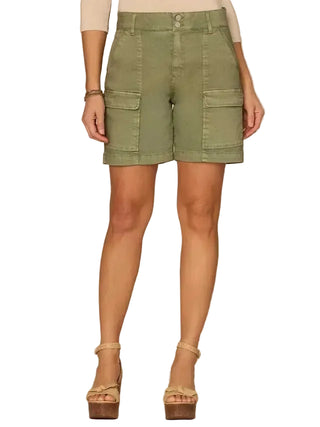 Green cargo shorts worn by a person on a beige background