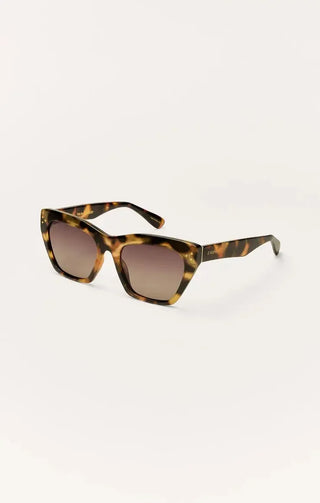 Tortoiseshell sunglasses with gradient lenses on a white background