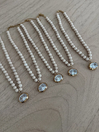 chunky white beaded necklace with a large CZ type stone