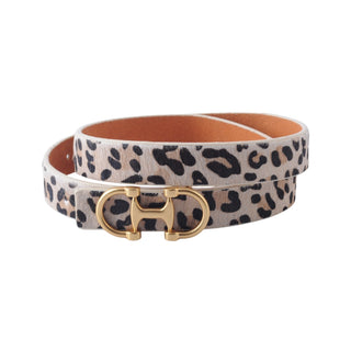 Leather belt with leopard print strap and gold buckle on a white background