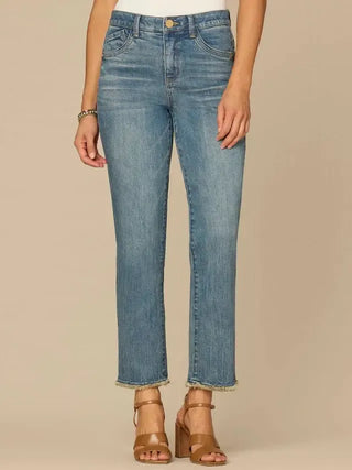Blue jeans worn by a person on a beige background