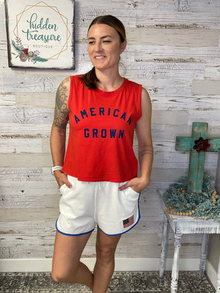 white terry cloth shorts with flag on the corner