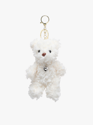 White teddy bear keychain with a gold ring on a white background