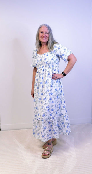 Woman wearing a floral dress against a white background